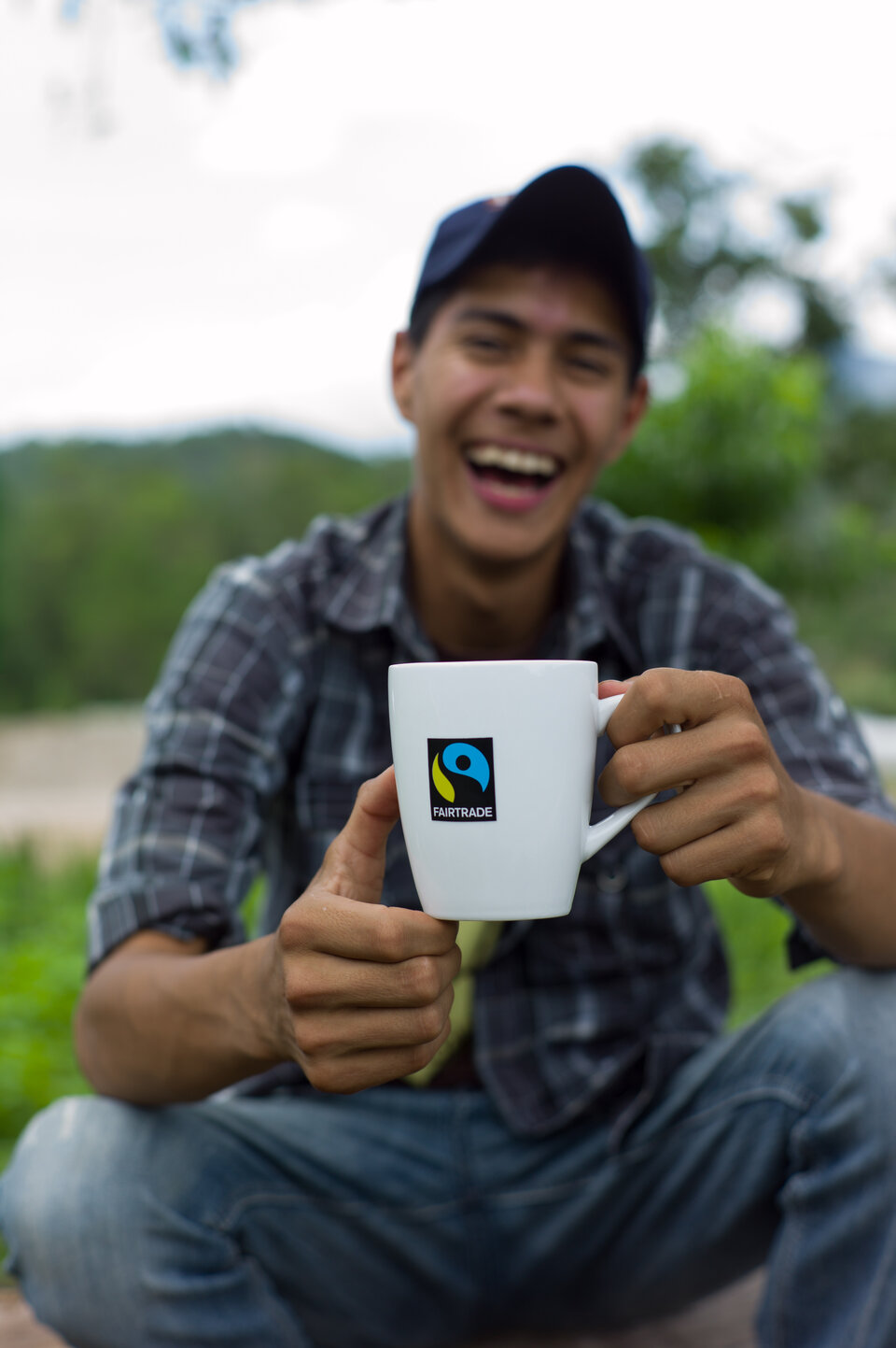 Kaffeebauer mit Fairtrade-Tasse in seinen Händen